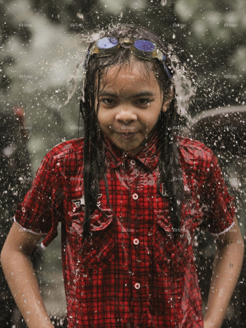 Taking a picture of my daughter while she was playing in the rain.
