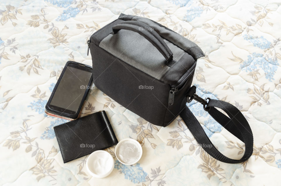 Bag, Phone And Card Holder On Bed