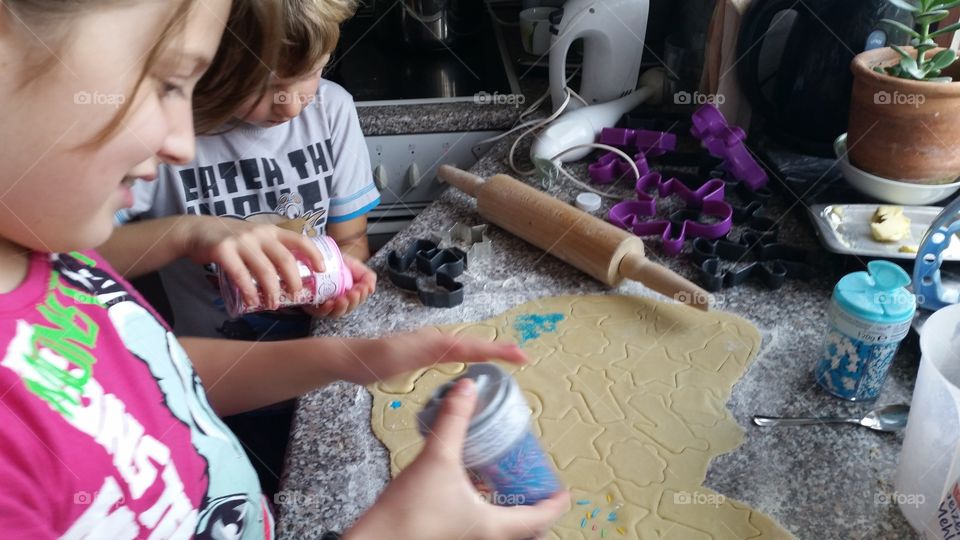 Children helping mama making Christmas cookies