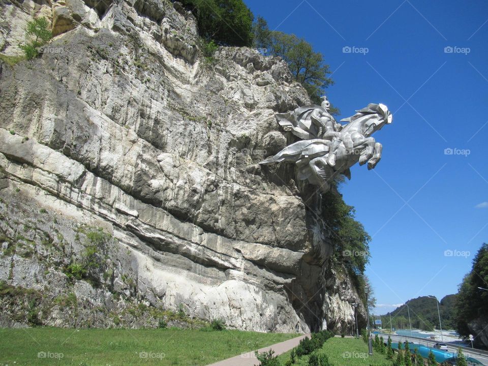 monument, image of St. George the Victorious on a rock in the mountains of Ossetia, North Caucasus, Russia