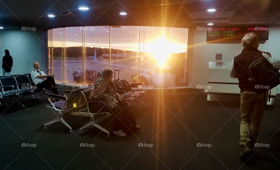 People wait to board a plane in the early morning 