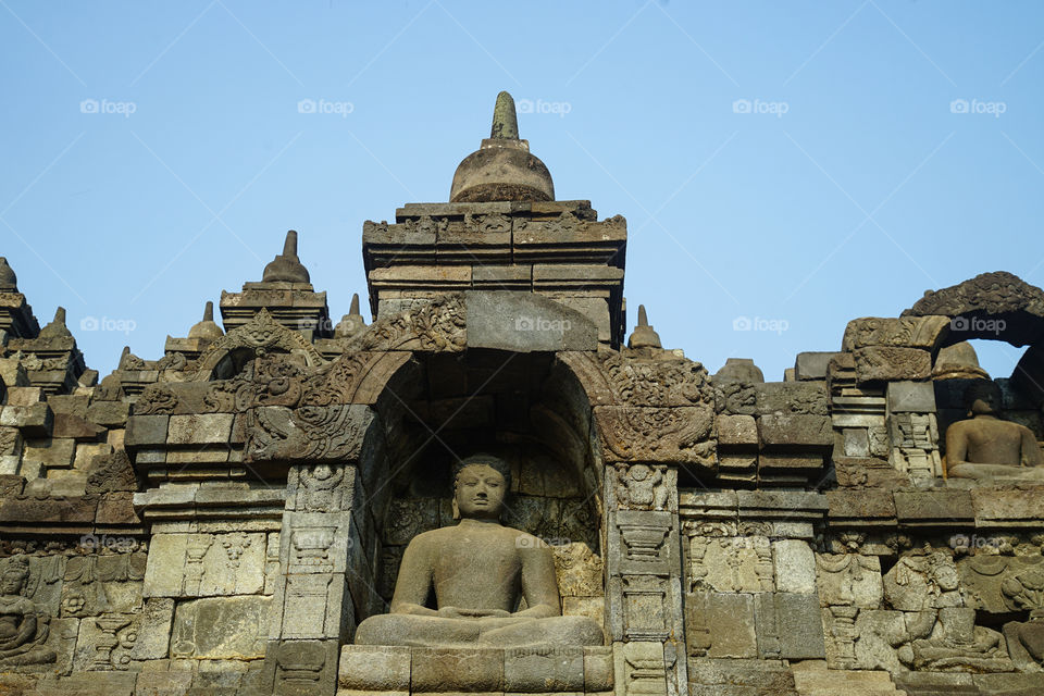 one of the statues of buddha in borobudur temple