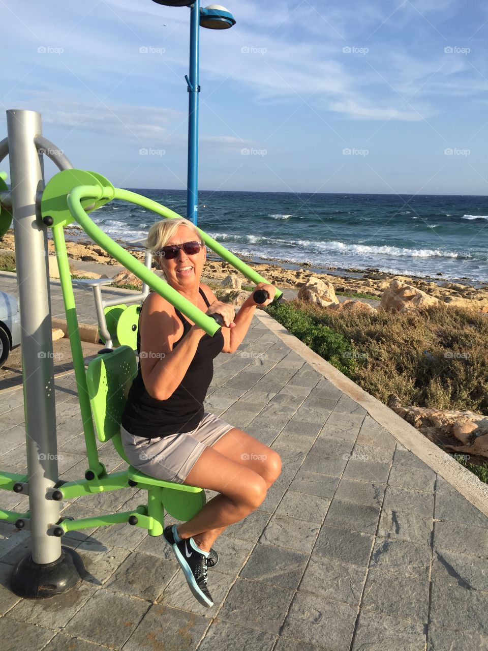 Woman exercising with chest press machine at outdoors