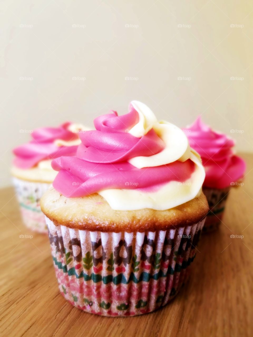 Pink and yellow icing on a cupcake