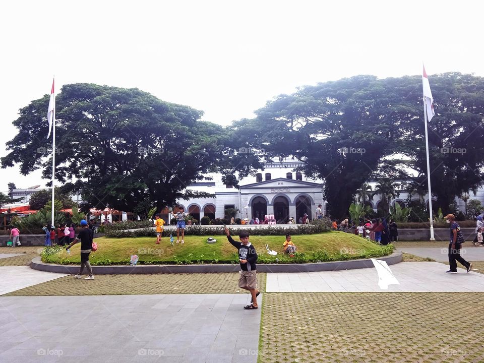 A boy playing kite in Bogor town square, West Java, Indonesia
