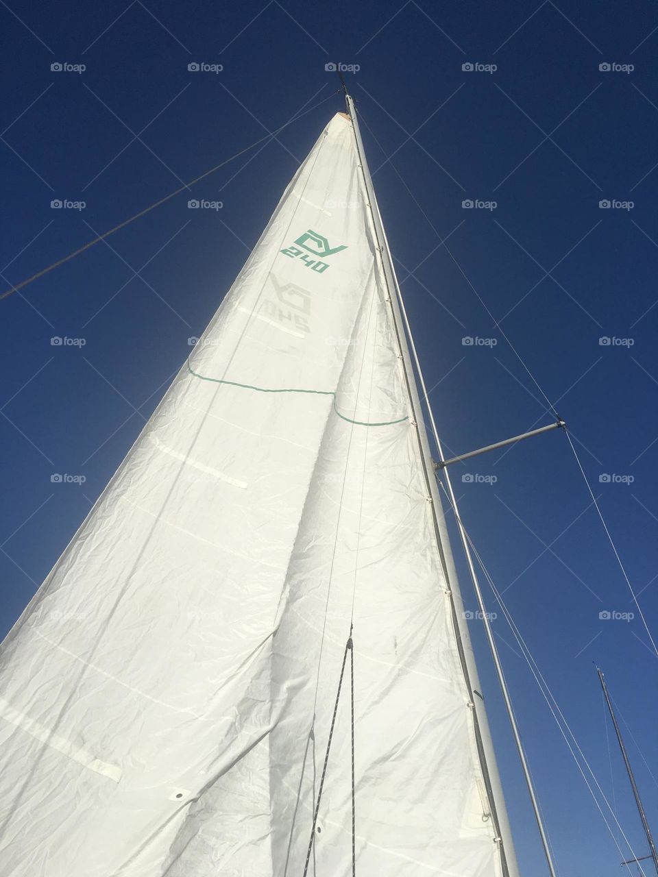 The hoisted sail of the “Salvation” against a clear blue summer sky at Newtown Creek in Long Island City, Queens, New York in 2017. Hypnotic Productions