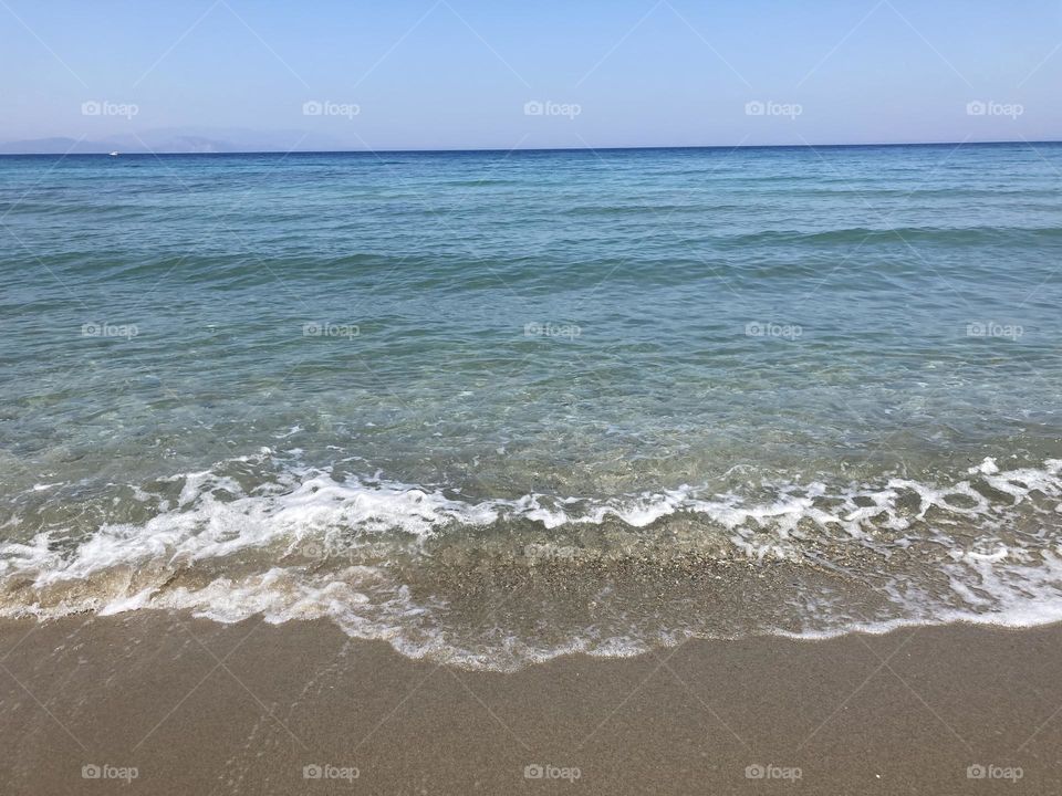 Beach time on holidays. Blue sky and tall palm trees. Sunsets and sunny days. Summertime in Kusadasi. Vacation travel in Turkey . Summer view. Sunny day during vacation 