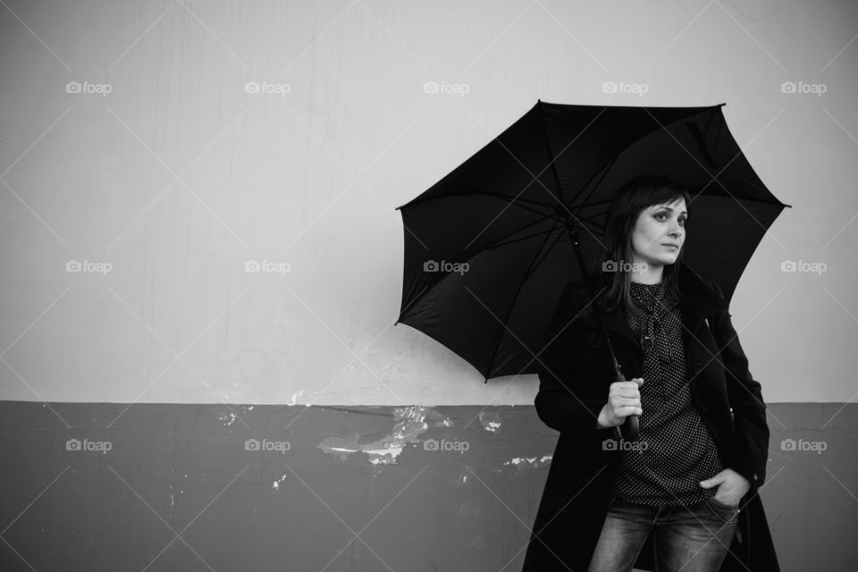 Serious woman holding umbrella