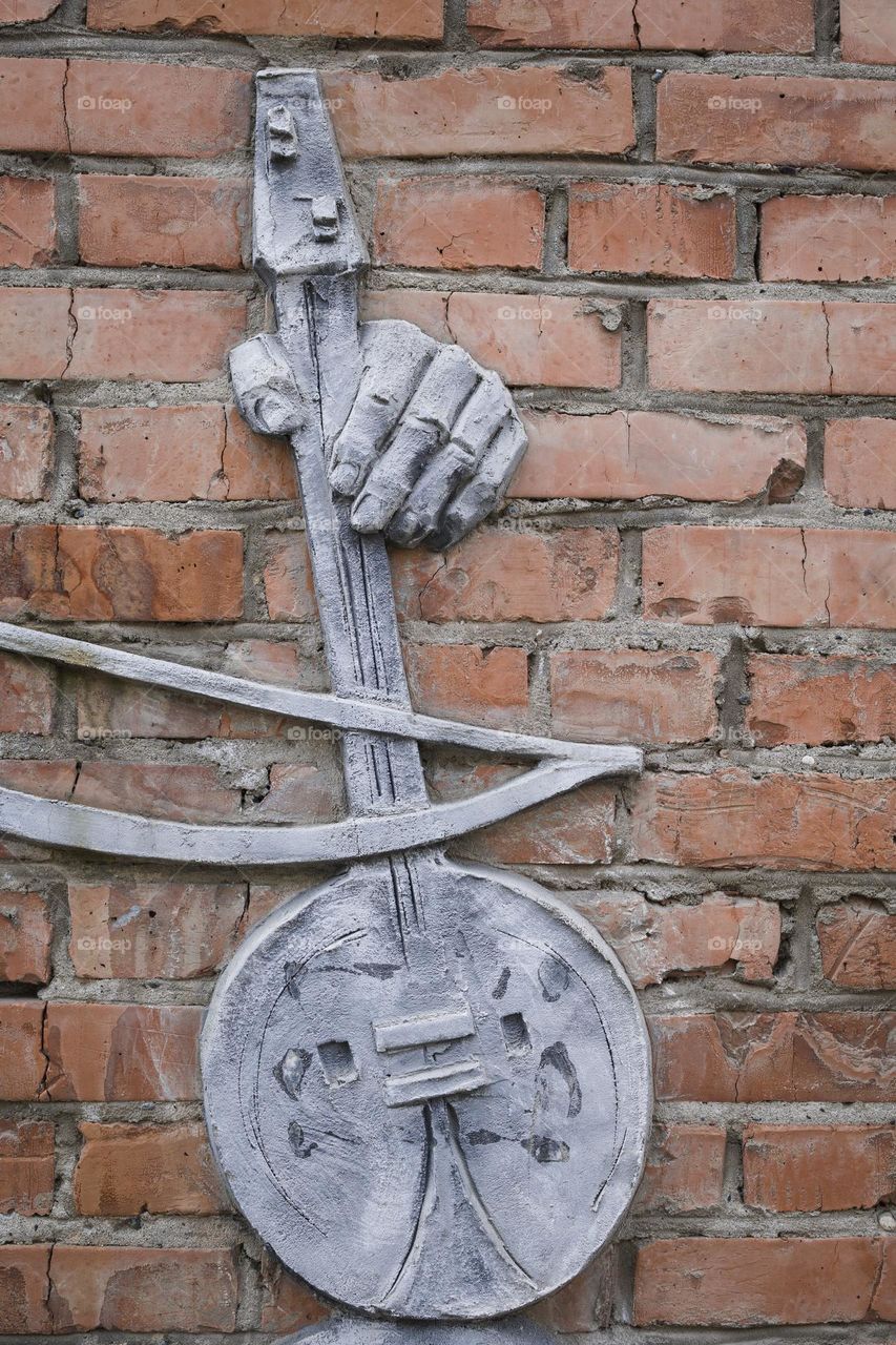 monument with fandyr. Fandyr is national music instrument of ossetian.