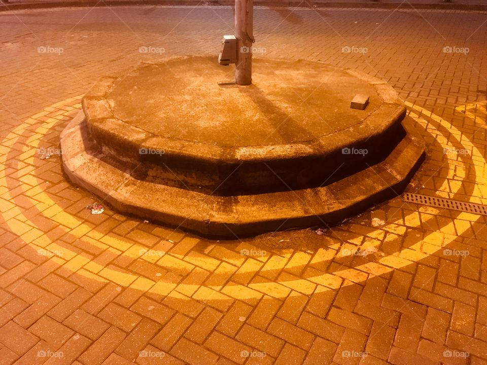 Mini roundabout in front of Edgware Underground Station, Middlesex, in Spring.