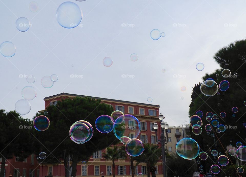 Bubbles in foreground of view of Place Massena in Nice, France.