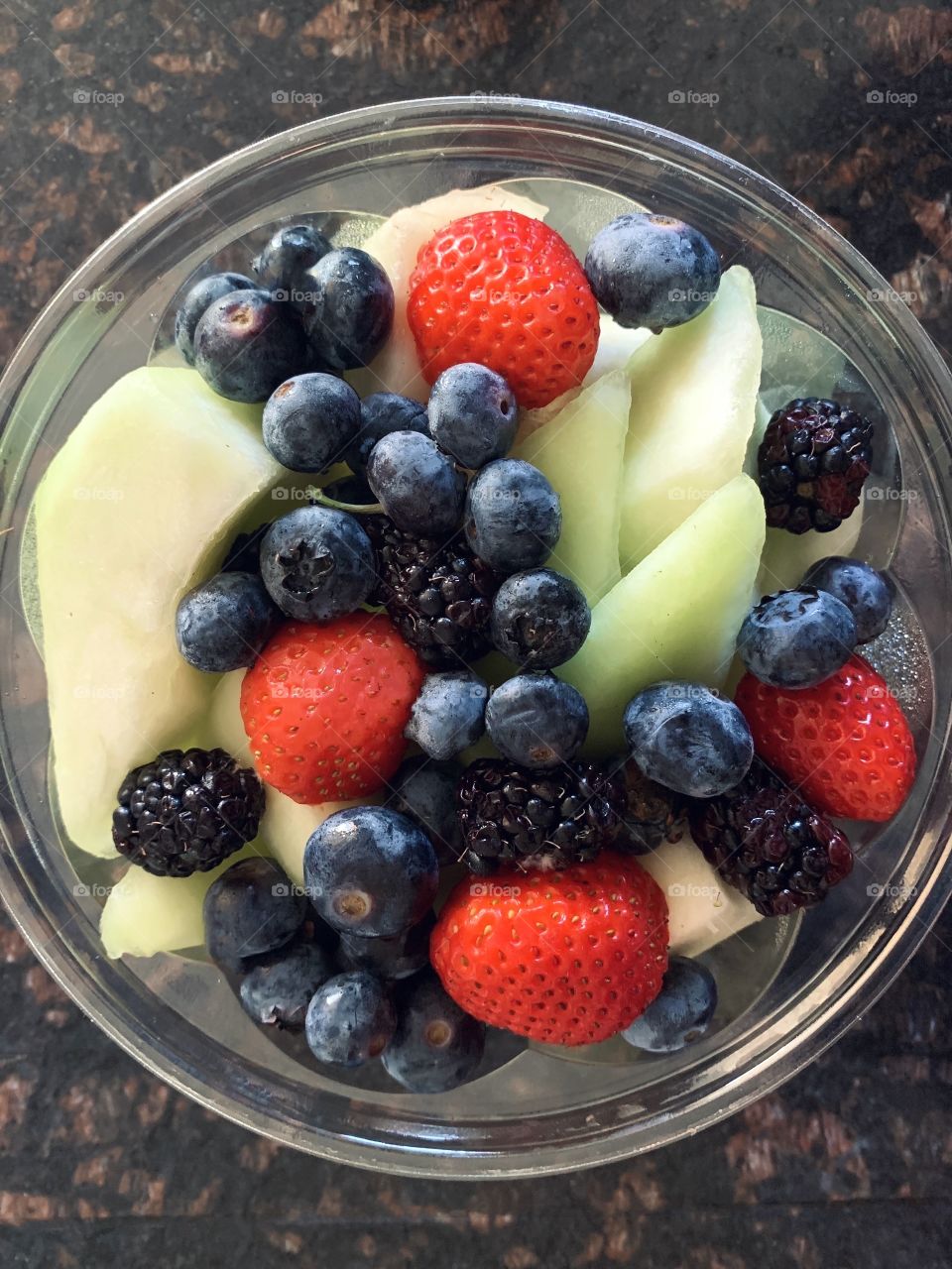 Healthy snack - fruit bowl - honey dew, blueberries and strawberries 