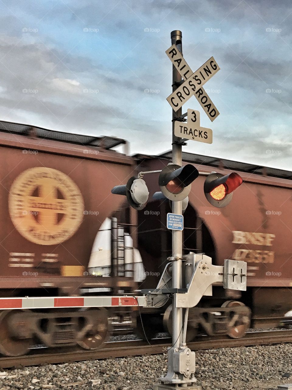 Railroad crossing and moving train. 