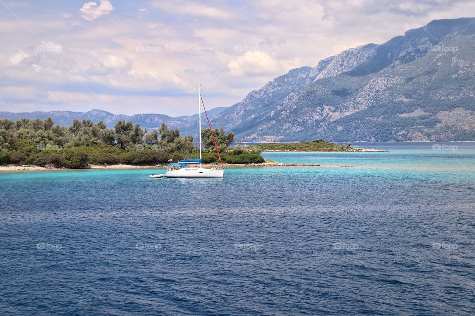 Yacht in the sea against the backdrop of mountains