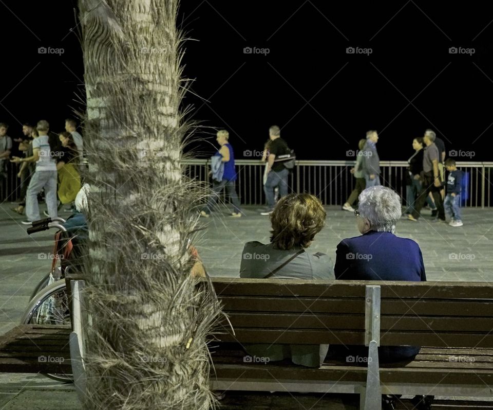 Elderly women sitting in a bench