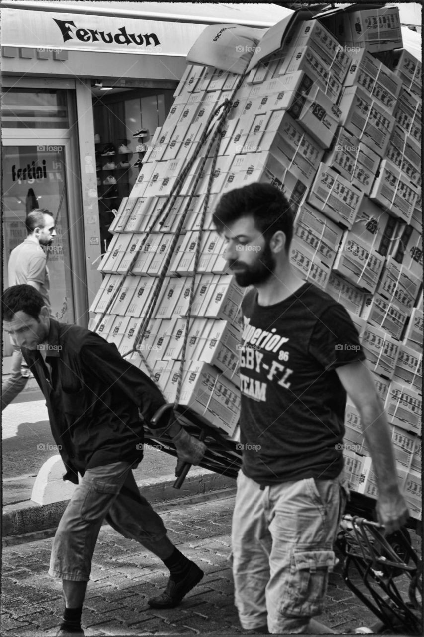 Istanbul Turkey street photography monochrome men carrying boxes in street