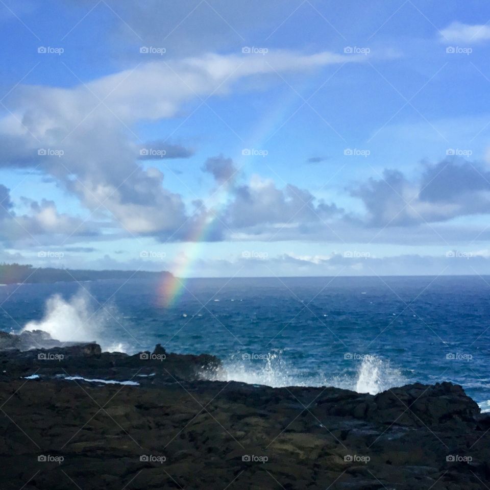 Rainbow and waves on the Kalapana lava flow.