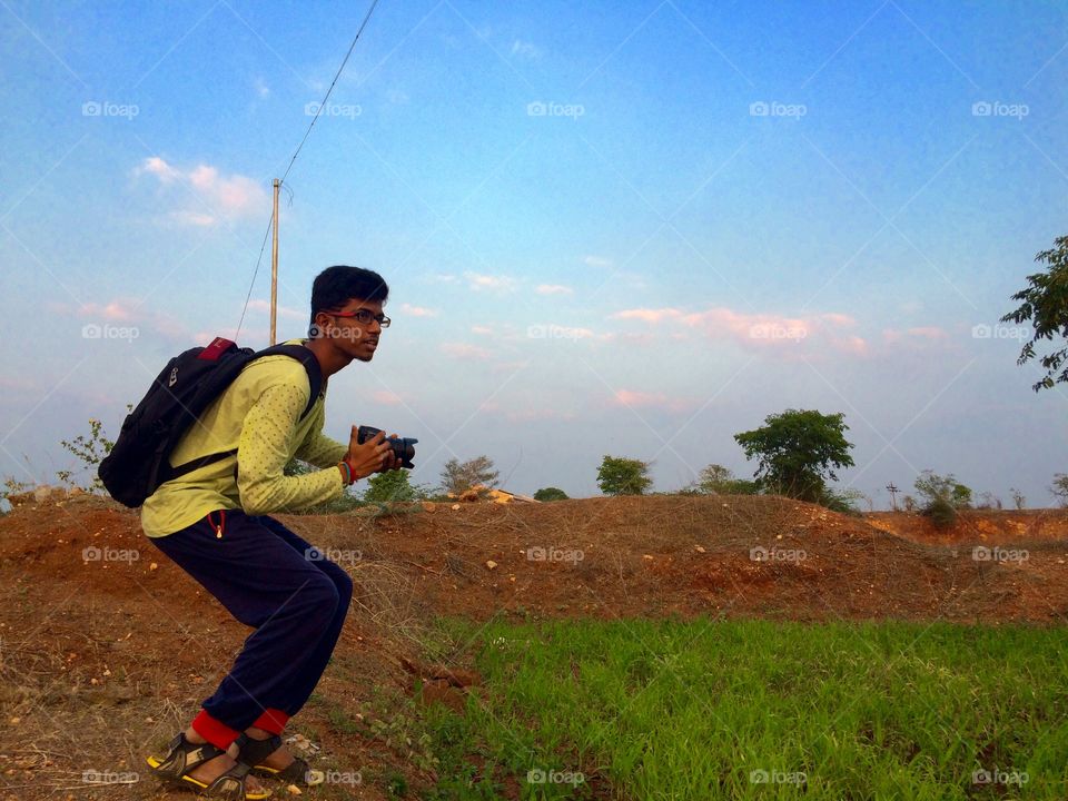 Teenage boy holding camera in hand