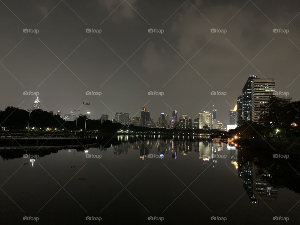 Clear sky, horizontal line of the city reflecting on the lake