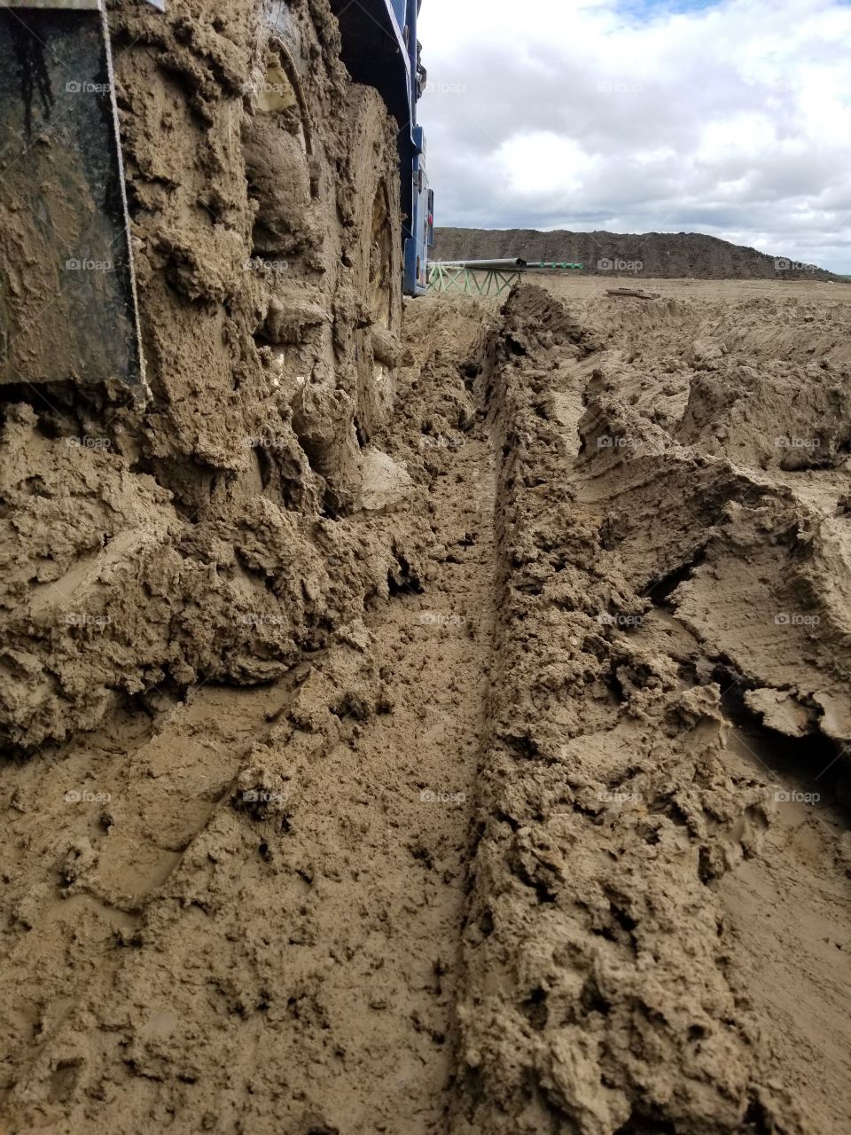 mud in truck wheels in a field