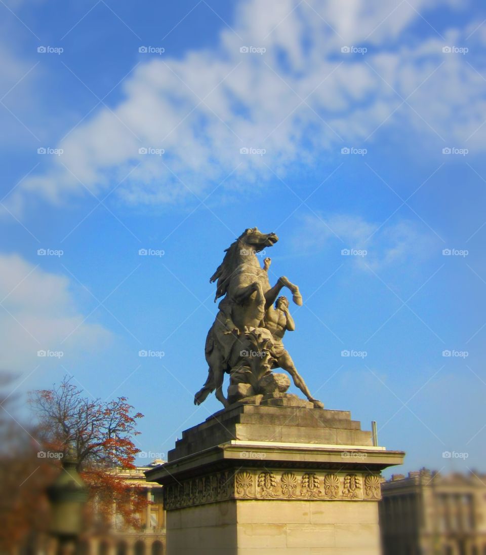 Paris and one of it's many statues.