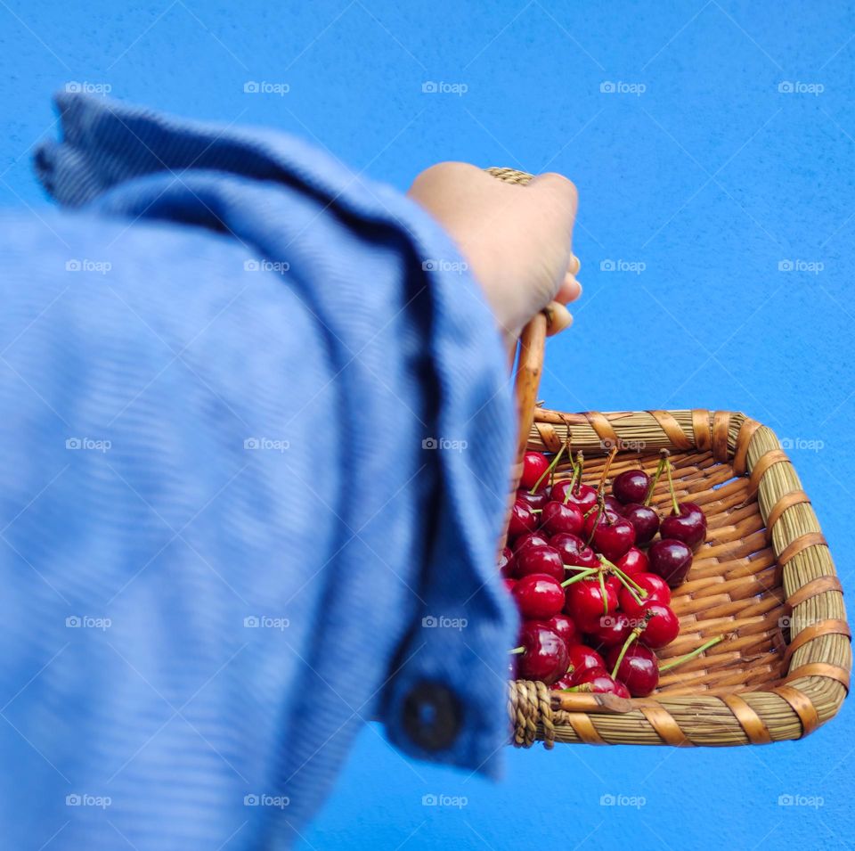 Red cherry basket and blue background