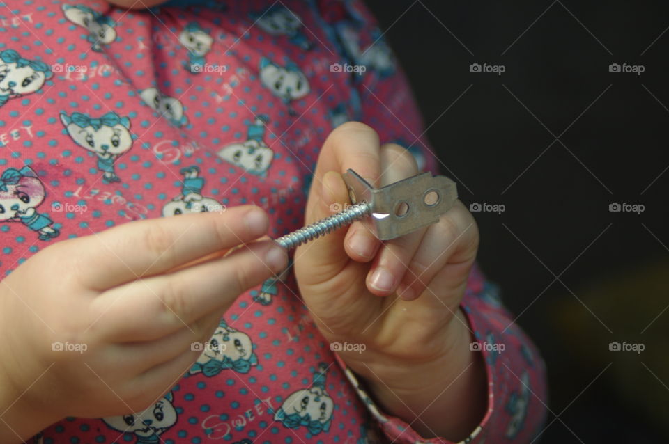 little girl holding tools