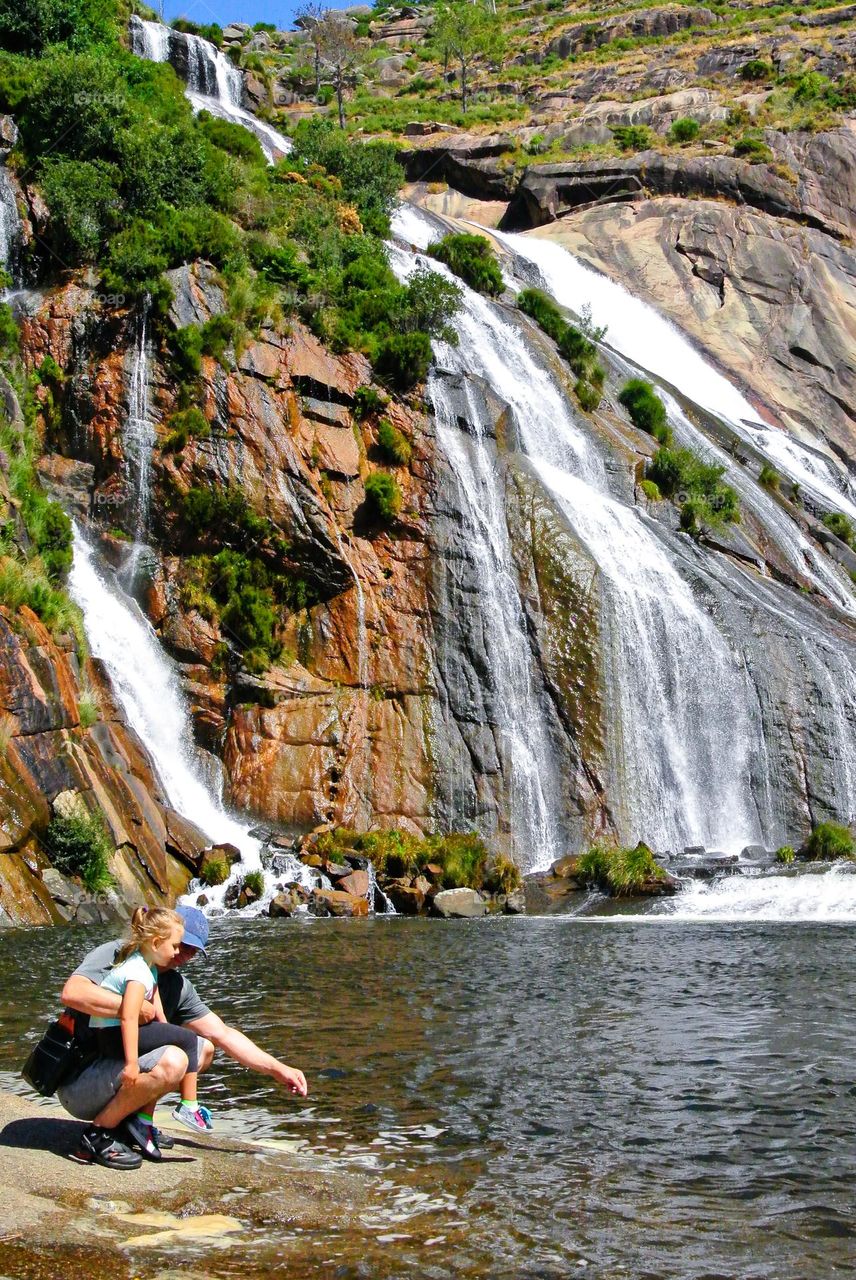 dad with daughter at the waterfall