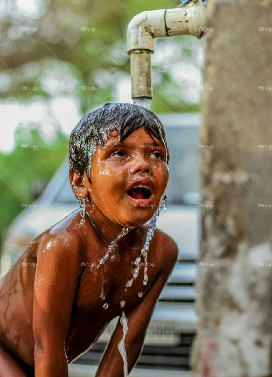 Thirsty Boy Enjoying Summer Bath