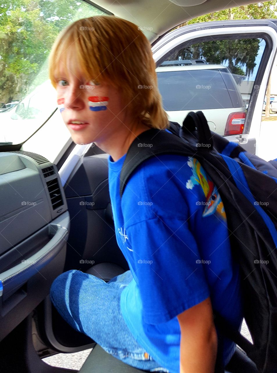 Close-up of boy sitting inside the car