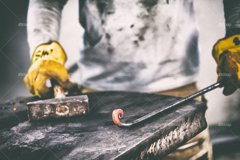 Person hammering red hot iron