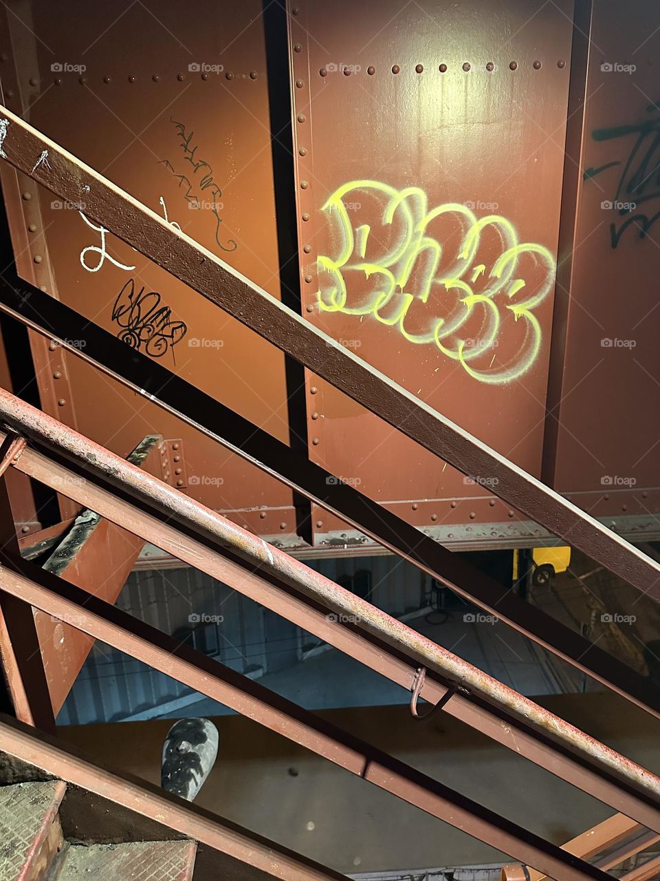 The “Pulaski Bridge” exhibits many angles and interesting expressionistic tidbits in the industrial minimalist aesthetic such as the red metal staircase with parallel bars in the railing and cubes with graffiti. 2023. Hypnotic Productions
