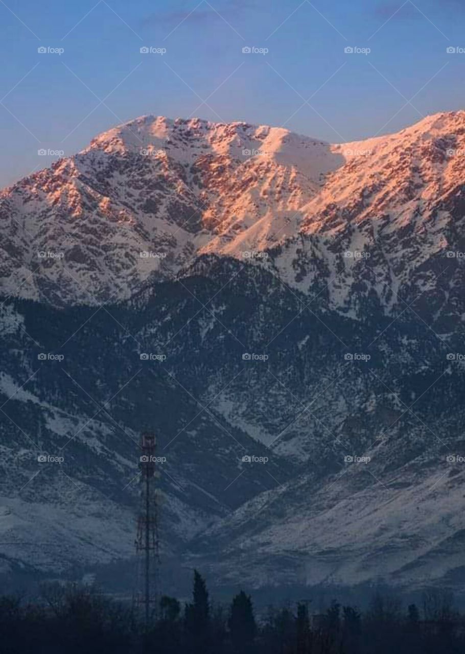 snowfall in mountain sunlight