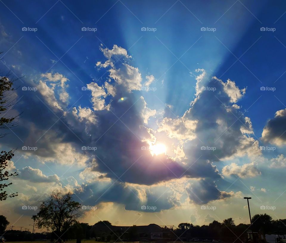 Amazing capture of mother nature and her endless beauty.  The sun getting ready to play hide and seek behind the clouds.