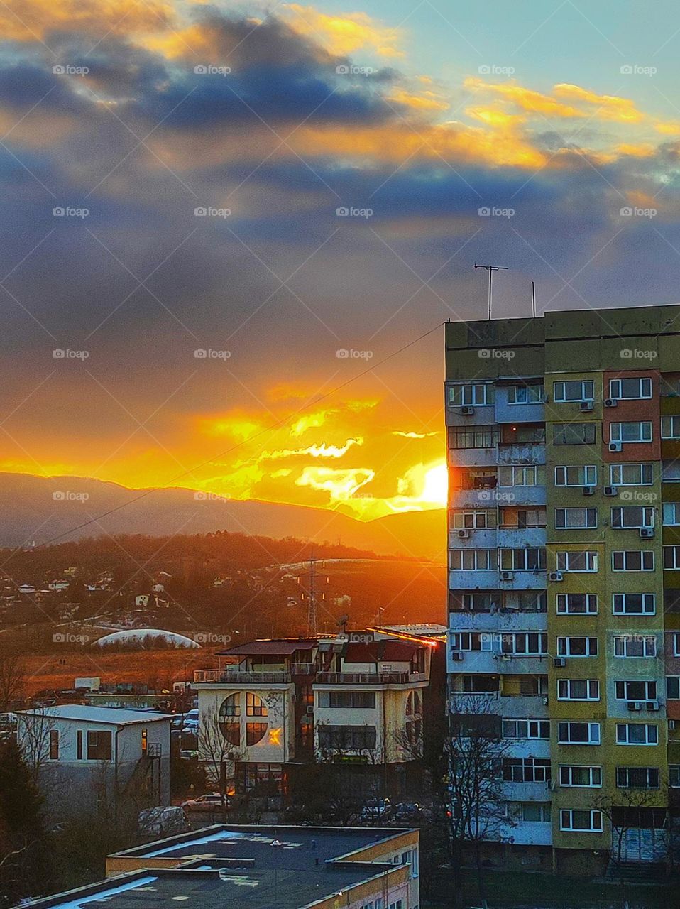 Beautiful sunset in the capital of Bulgaria with vibrant colours, clouds and apartment buildings