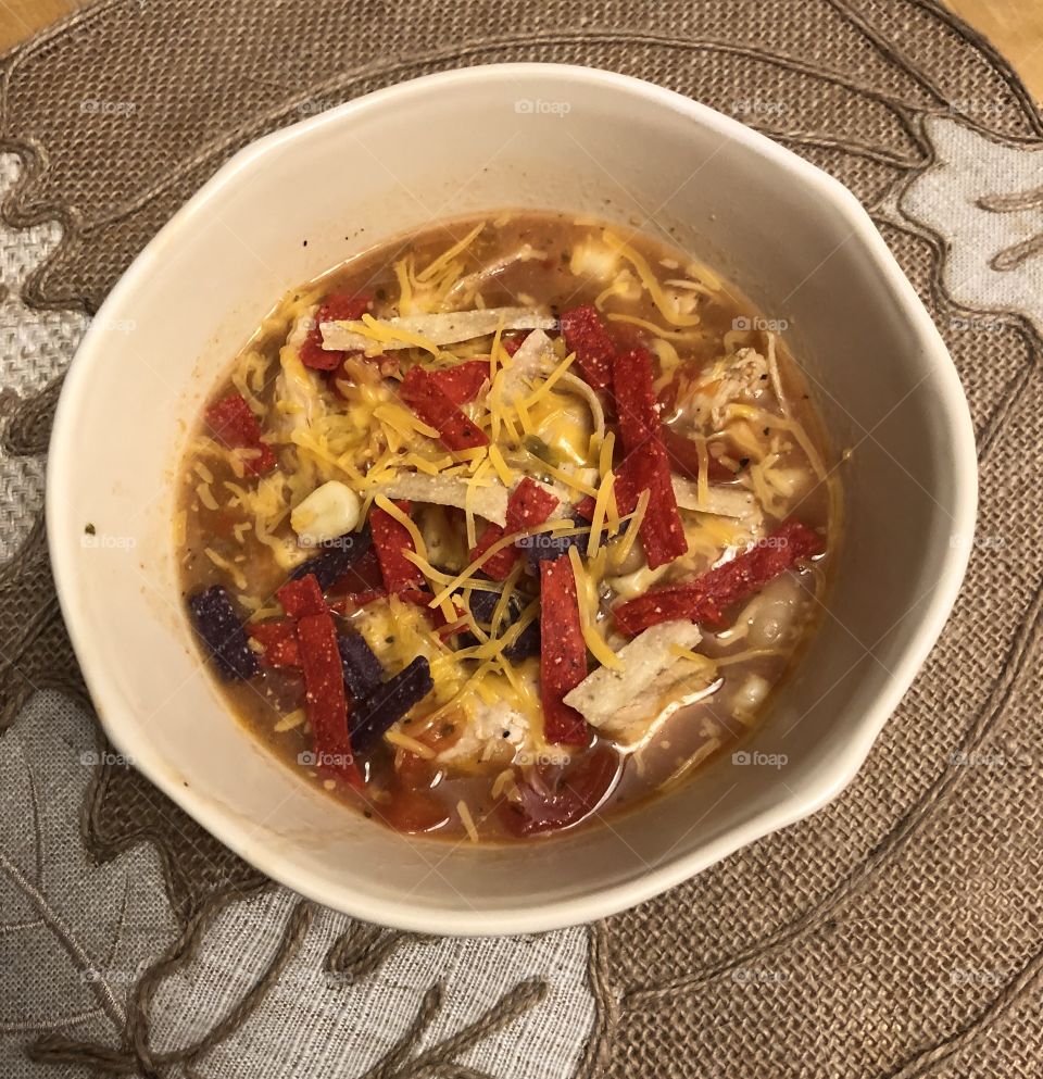 Bowl of White bean chicken chili with tortilla strips 