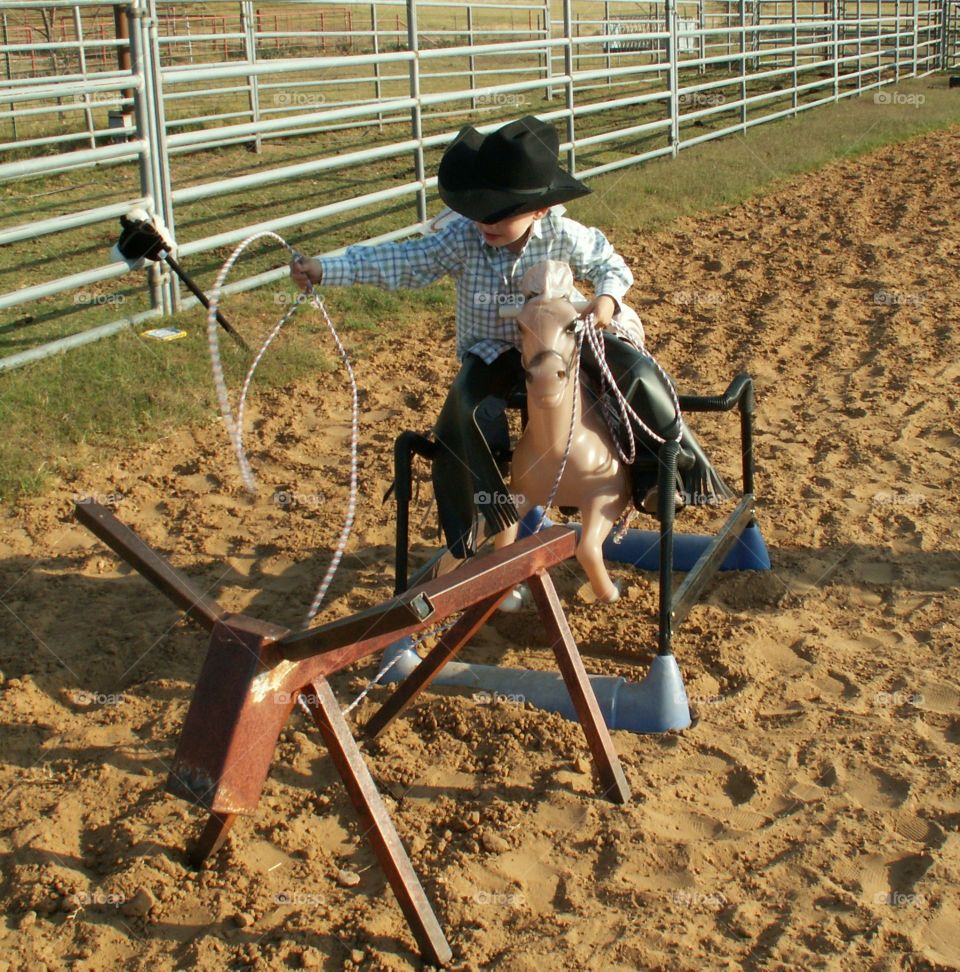 Stick horse rodeo - roping a steer dummy. 