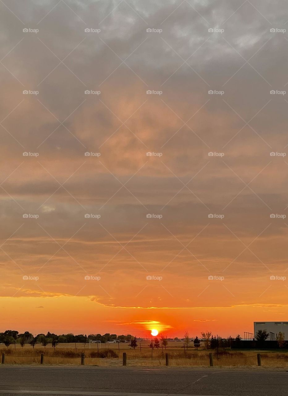 A cloudy day, over Medicine Hat, Alberta, Canada, makes this sunset so colorful in reds, oranges, yellows, and a hint of blue
