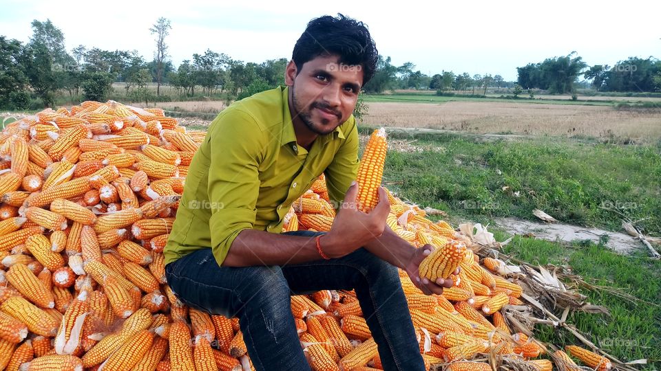 happy farmer with maize