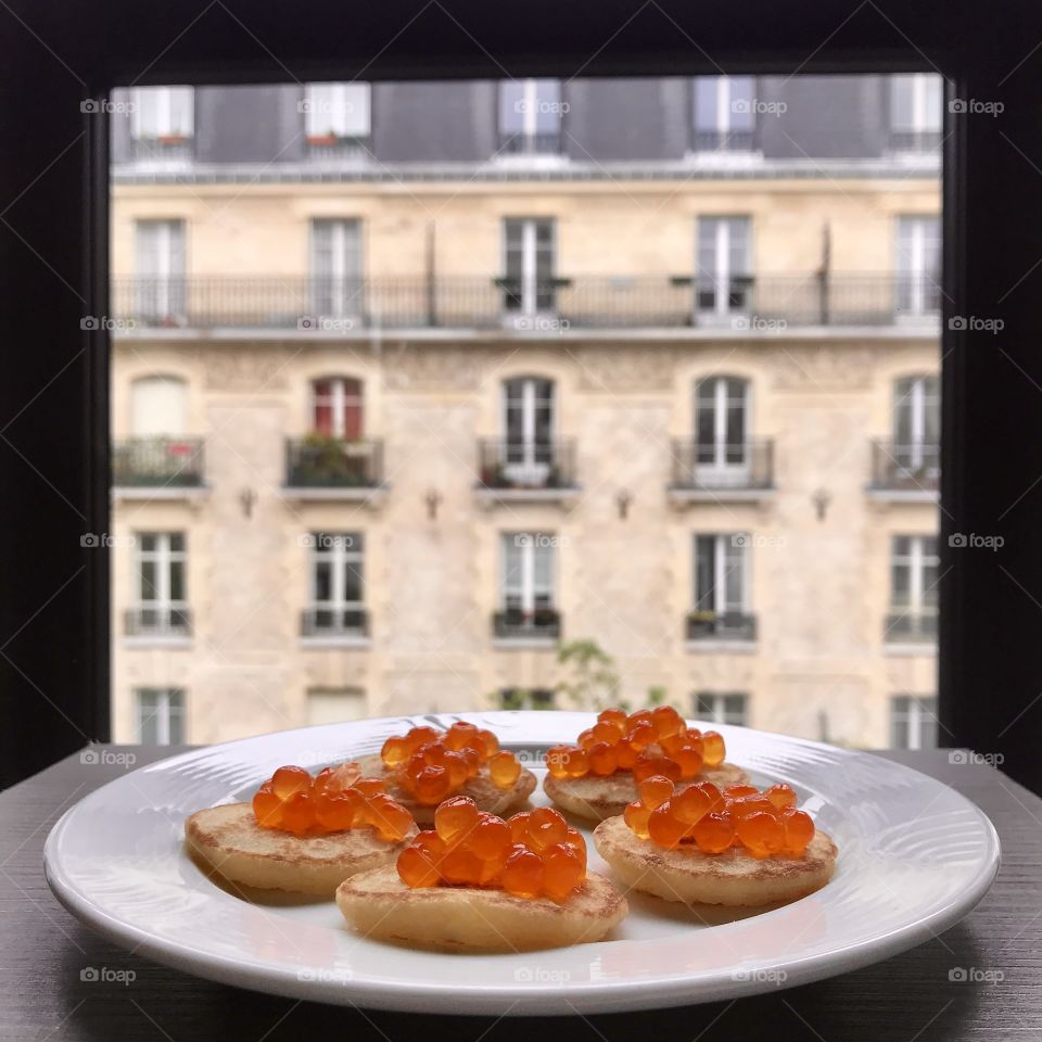 Breakfast in Paris. Traditional Russian pancakes with red salmon caviar 