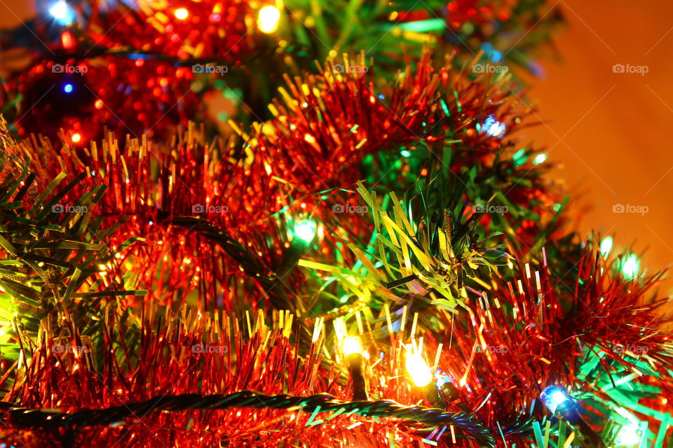 Macro shot of Christmas tree decorations and vivid lights