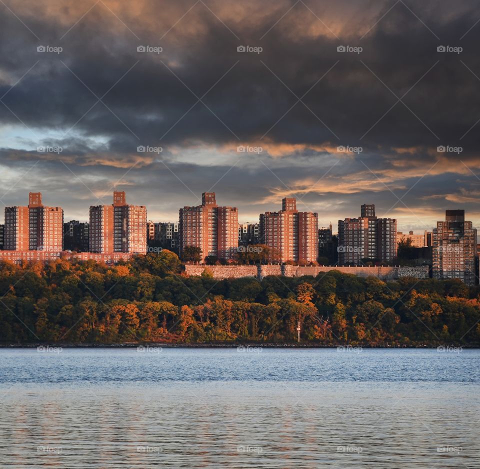 From a point of of view across the Hudson River from the New Jersey side an ominous sky descends upon apartment buildings in Washington Heights of New York city.