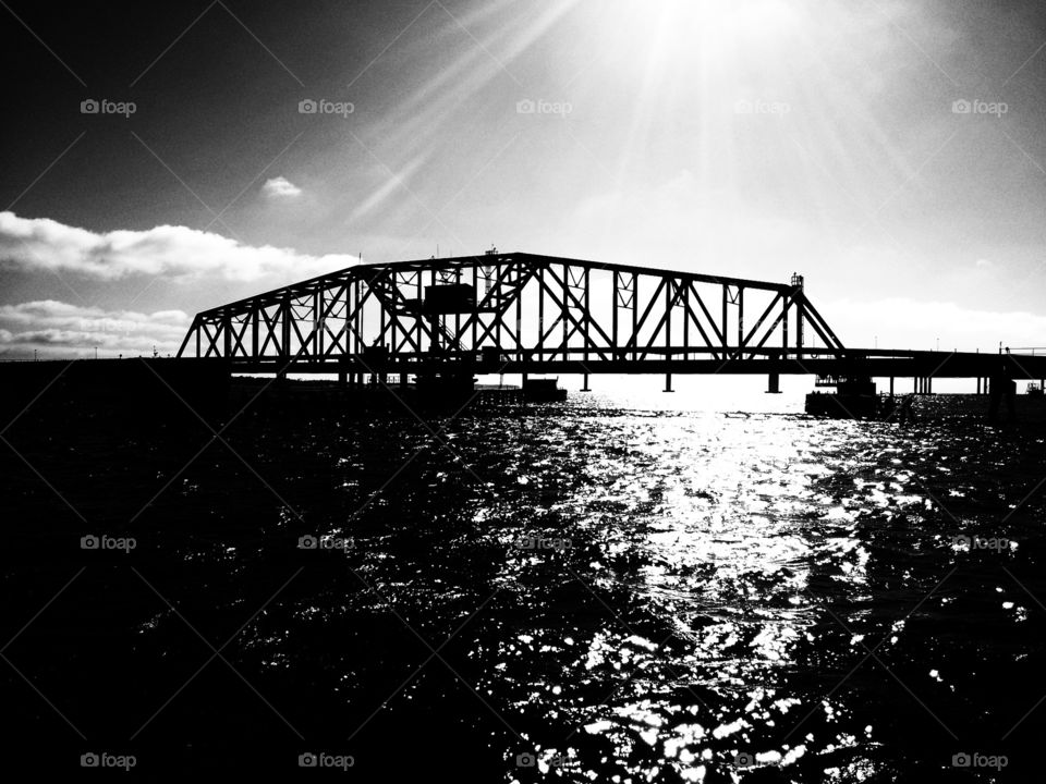 Railway bridge at sunset in black and white