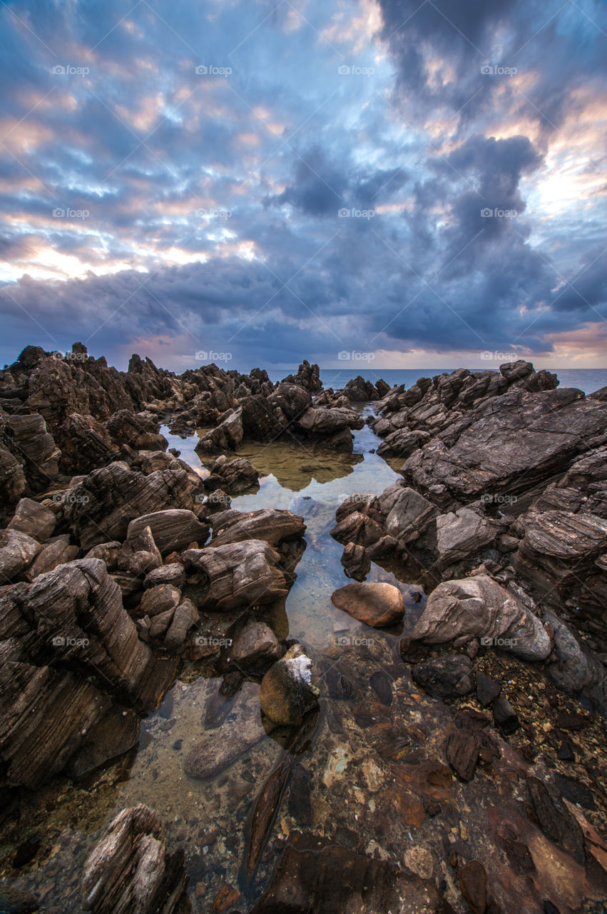 Rocky shore and sunset in the Caribbean.