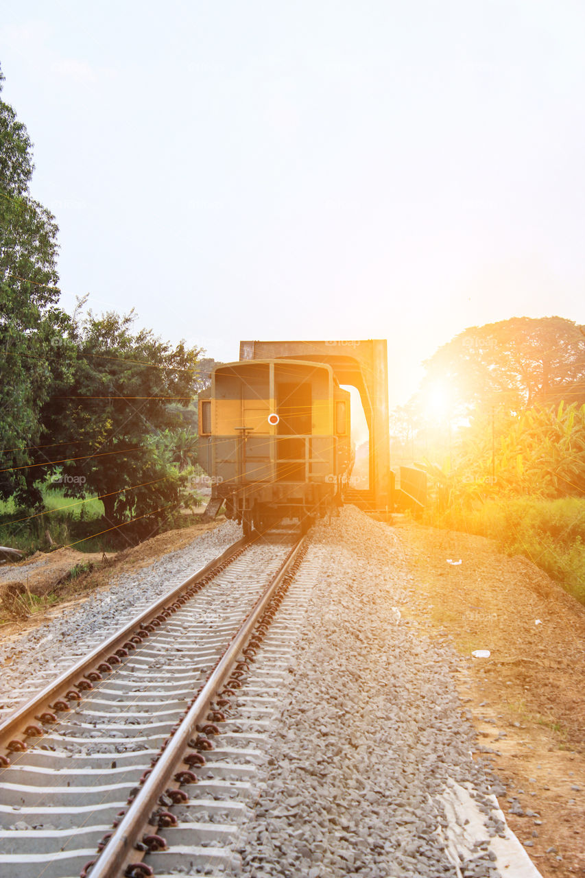 train on rail way with sunrise