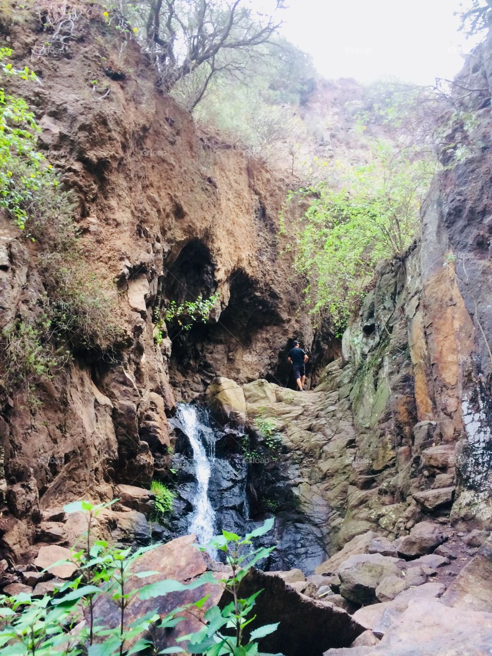 Beautiful waterfall between coloured rocks 