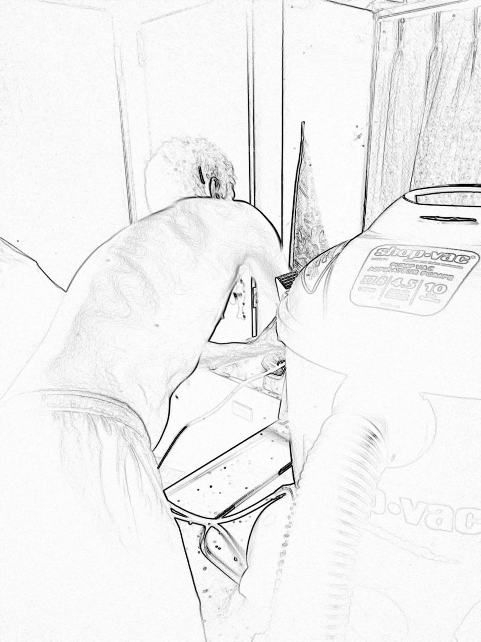 Man in the kitchen fixing the sink
