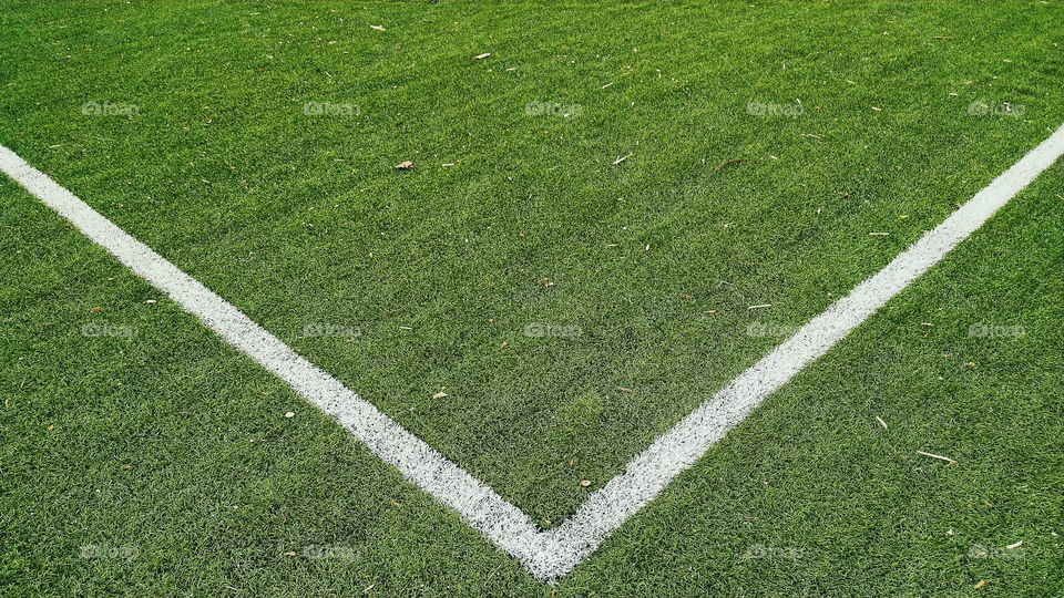 white markings on the green grass of a football field