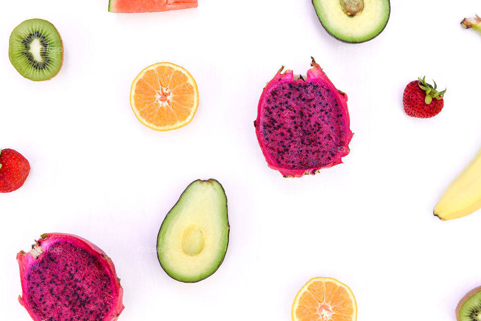 Flat lay of an assortment of halved fruits 