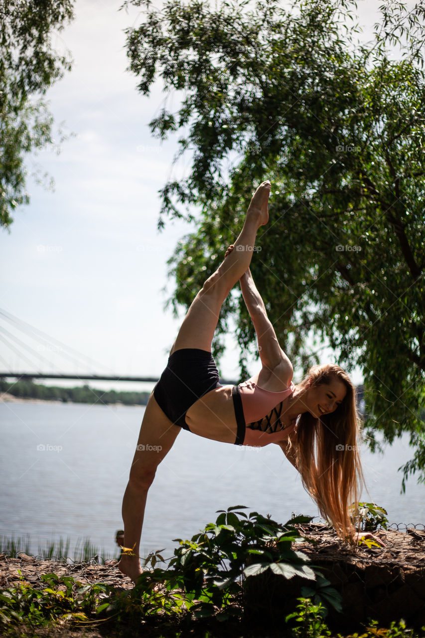 young woman doing yoga in the park